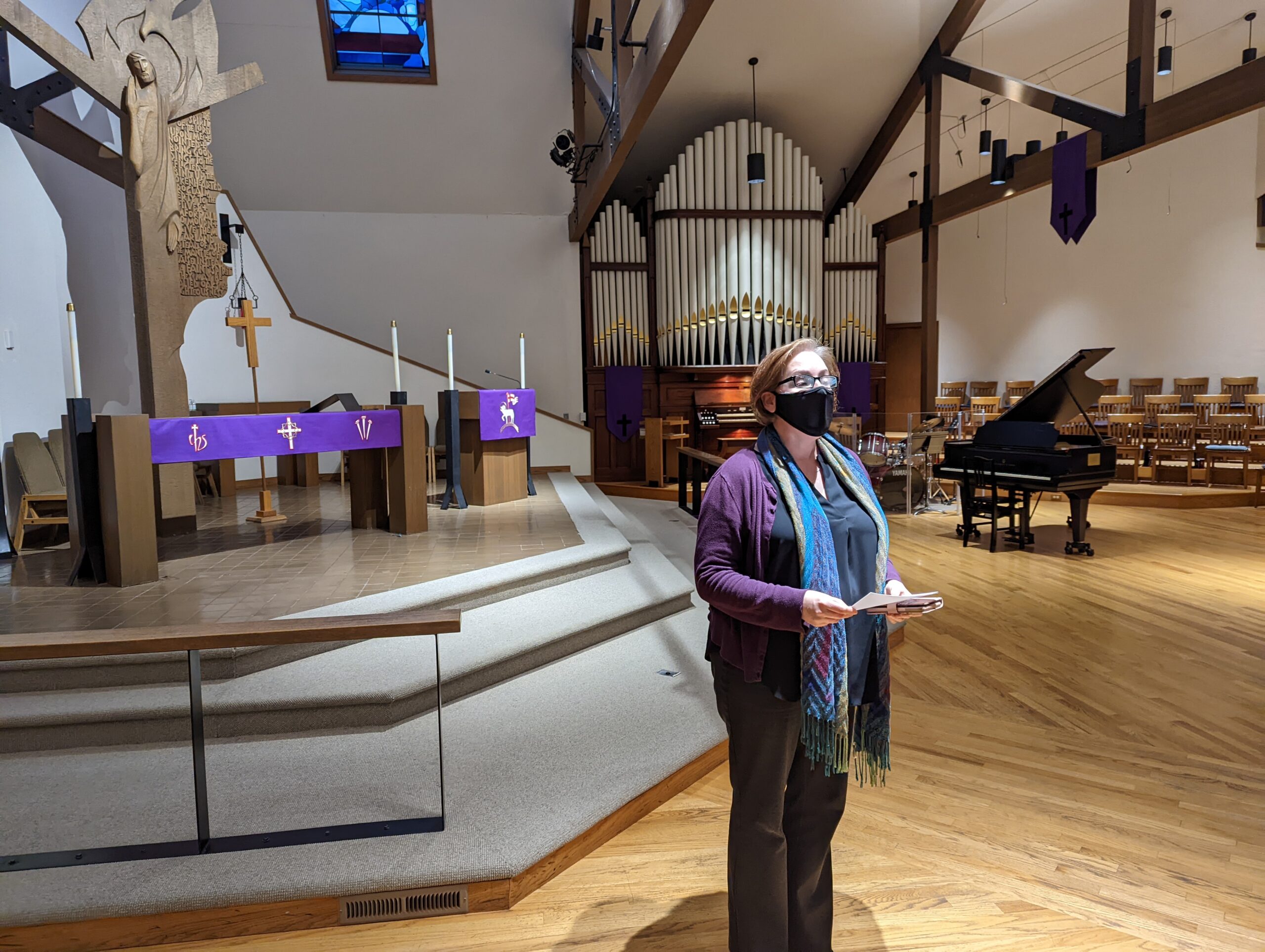 Dean Sheila Bristow standing at front of church holding notes