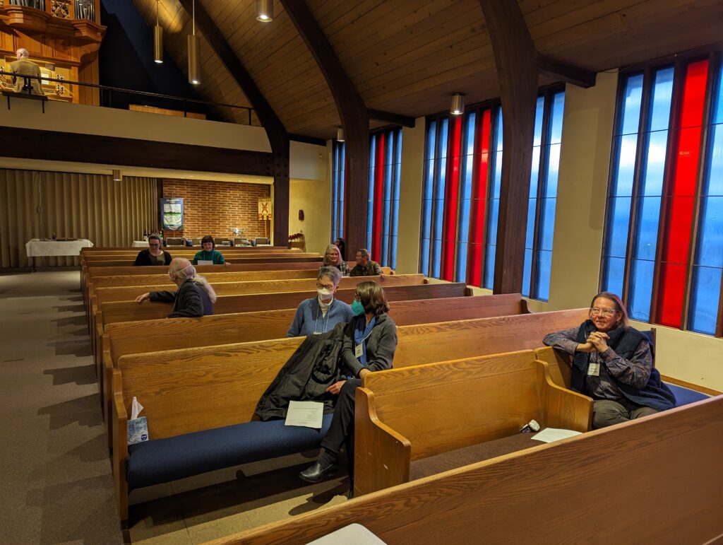 Nave of church with people sitting in pews