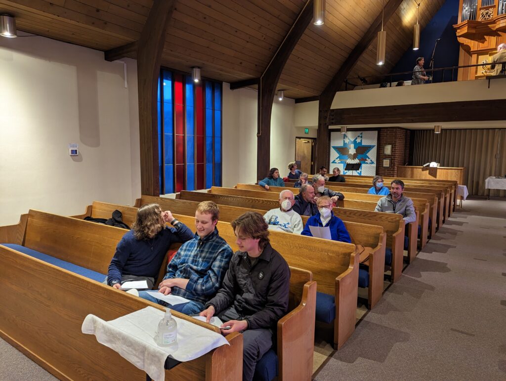 Nave of church with people sitting in pews